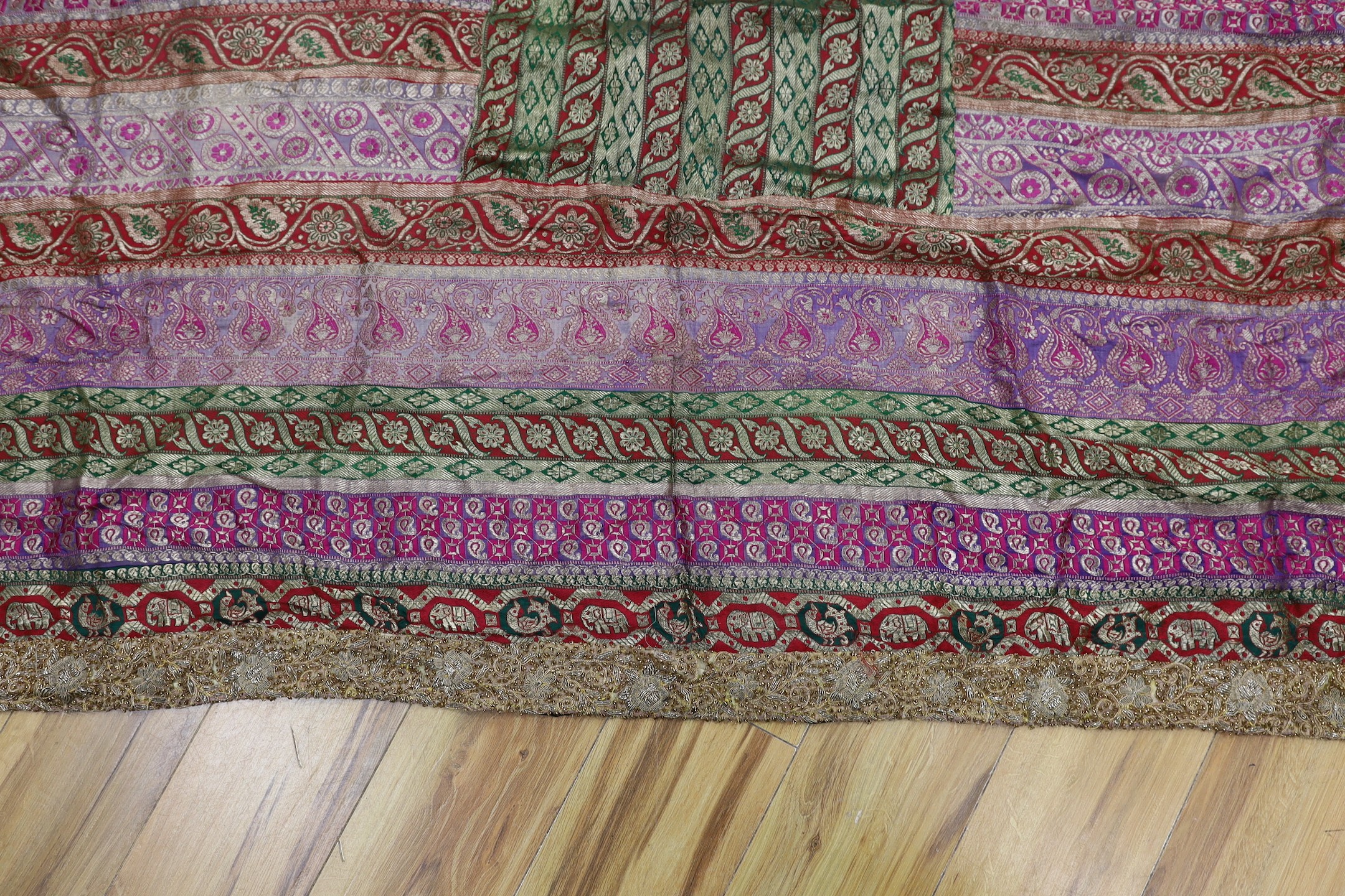 A French 18th century woolwork cushion, 2 chair covers, another panel, a tasselled brocade cushion and an Indian metallic brocaded patchworked cover